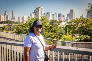Marge at Benchakitti Park with Bangkok skyline - slow travel Thailand