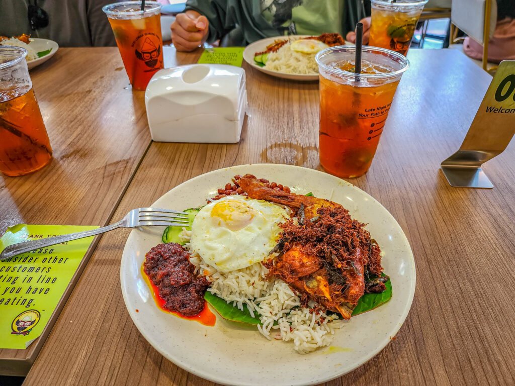 Nasi lemak with iced tea at a local restaurant in Malaysia — full-time slow travel lessons food finds