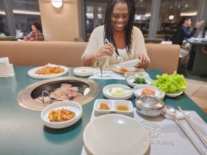 Marge enjoying Korean BBQ during a year of full-time slow travel